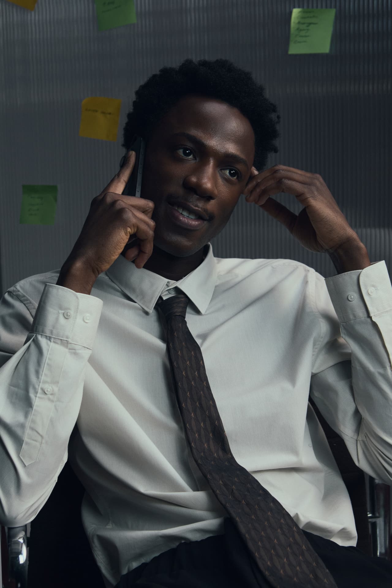 A concierge taking a call at his desk